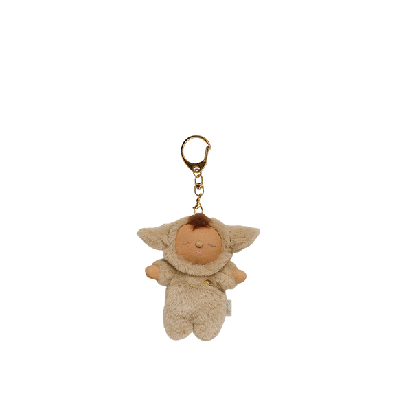 Plush keychain of a baby character with a gold ring on a white background
