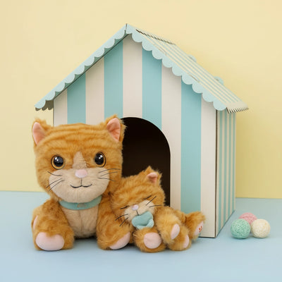 Stuffed cat with a striped pet house on a light blue background