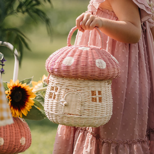 Olli Ella Rattan Mushroom Basket - musk and white coloured held by girl