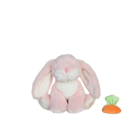 Pink plush bunny toy with a small carrot on a white background