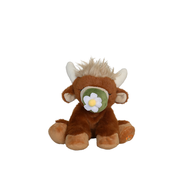 Plush toy bull with a flower on a white background