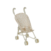 Miniature stroller with rainbow patterns on a white background