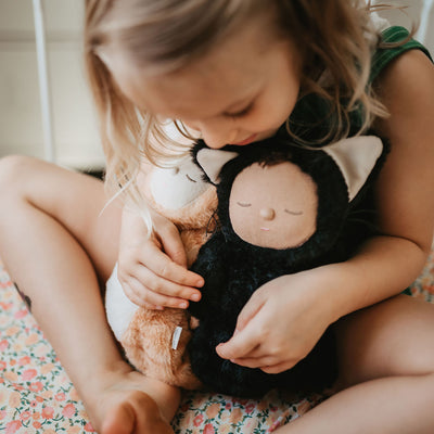 Image of a little girl loving a black cat and a tabby cat, soft plush toy doll for kids