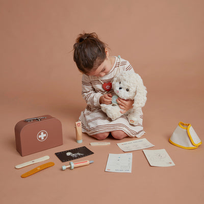 Olli Ella Dinkum Dog Vet Accessory Set child using on dog Cookie