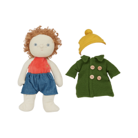 Stuffed doll with red shirt, blue shorts, and yellow hat next to a green coat on a white background