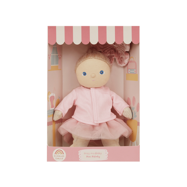 Doll in a pink outfit with a matching box on a white background