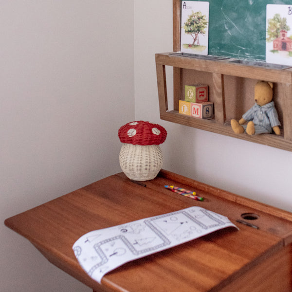 red mushroom basket made with rattan. Comes with wooden colouring pencils for the ultimate kids play kit.