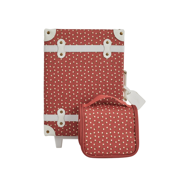 Olli Ella Christmas Theme See-ya Washbag red print pictured with suitcase