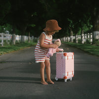 Kids strawberry print carry on suitcase for travel. Matching strawberry print soft doll for kids